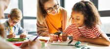 Teaching assistant helping pupils