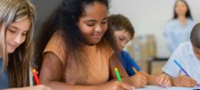 Children writing in classroom