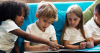 4 primary school children sitting together