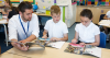 male teacher with a girl and a boy in classroom