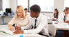 female teacher with boy of colour in a classroom