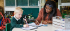 teacher with boy in green uniform