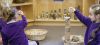3 girls in purple uniform playing in a classroom