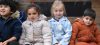 children in anoraks sitting