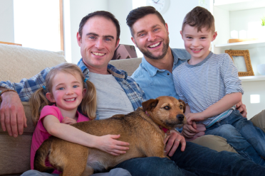 Happy looking family with pet dog